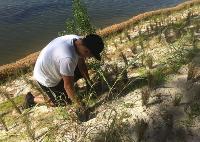 Volunteer planting native vegetation at Bayou Grande