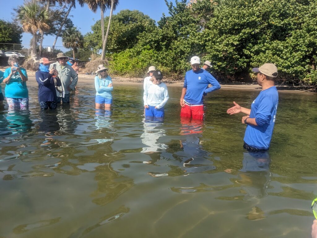 Group of people standing in the water at a training course at Riverside Park